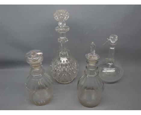 Group of four 19th/20th century clear glass decanters to include two three-ringed mallet formed decanters, etched decanter an