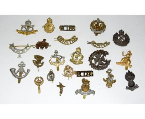 An assortment of 23 British Army badges and titles