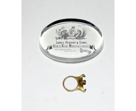 A James Purdey & Sons Gun and Rifle Manufacturers Oxford St London paperweight 10cms x 7cms x 2cms and a vintage brass 12 bor