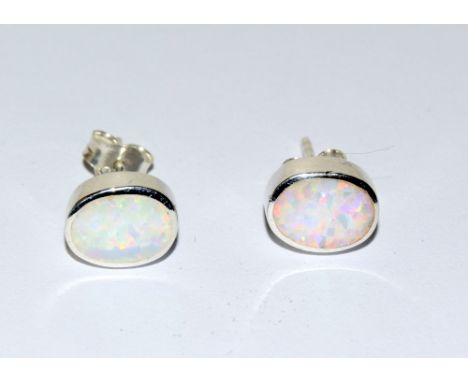 A pair of opal and stud earrings