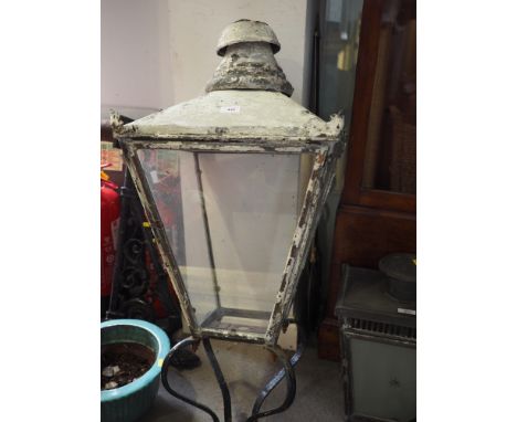 A late 19th century copper street light with four glazed panels and cast iron wall bracket, 40" high 