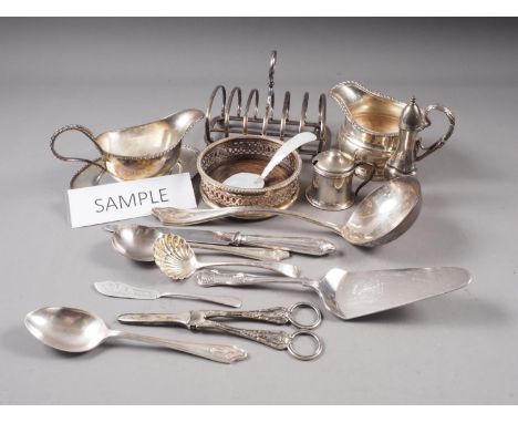 A selection of silver plated flatware, a pair of silver bottle coasters, a plated pepper grinder, a plated toast rack and oth