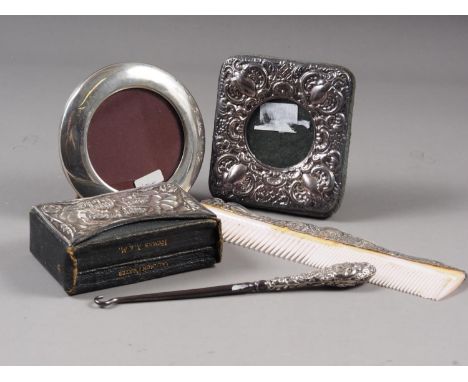 Two silver photo frames, a book of common prayer, and a book of hymns with silver mounted sleeve, a silver mounted comb and a