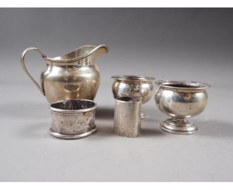 A silver cream jug, a pair of silver pedestal salts, a silver napkin ring, a silver christening mug, a Georgian silver shell 