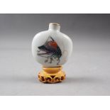 A Chinese porcelain snuff bottle, decorated crickets, seal mark to base, on wooden stand, 2 1/4"