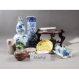 A large selection of Chinese ceramics, wood stands, etc