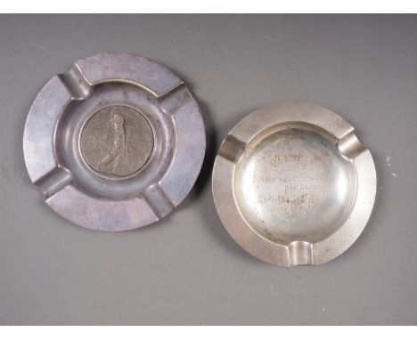 A silver ashtray with engine turned and engraved decoration, 3.4oz troy approx, and a silver plated ashtray with inset golfin