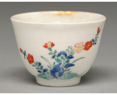 A Kakiemon cup, Edo period, c1700, with rounded sides and slightly everted lip, enamelled with two clumps of flowering plants