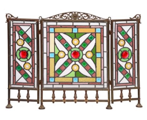 A Victorian brass folding firescreen, c1900, with three leaded polychrome glass lights, 60cm h Lacquer discoloured / worn; po