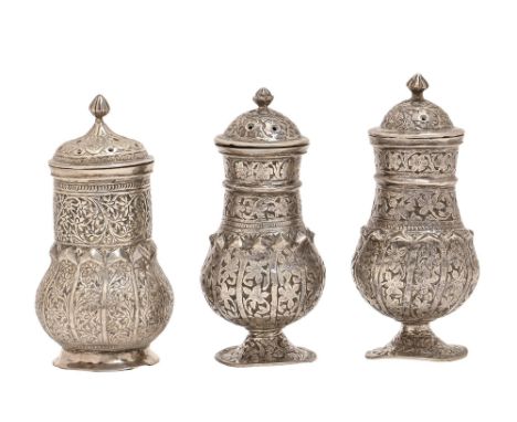 One and a pair of Indian silver pepperettes, 19th / early 20th c, decorated with flowers and foliage, 85mm h and circa, 7ozs 