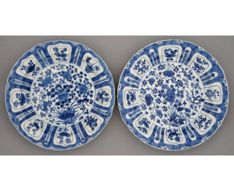 Two Chinese blue and white dishes, Kangxi period, painted with lotus or flowers, the border of lotus shaped floral lappets on