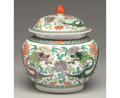 A Chinese famille verte jar and cover, 19th / 20th c, enamelled with dragons and flowers in diaper border, 23cm h, Kangxi mar