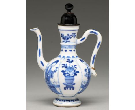 A Chinese moulded blue and white condiment ewer, Kangxi period,&nbsp;the lotus shaped panels and painted with a young woman a