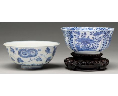 A Chinese blue and white fluted bowl, 18th c, painted to the well with two flowering plants growing from a blue rock bordered