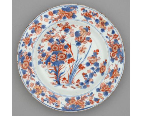 A Chinese Imari plate, 18th c, painted with three clumps of flowering plants bordered by trailing flowers, 27cm diam Small ch