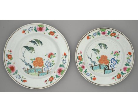 A graduated pair of Chinese famille rose dishes, 18th c, painted with peonies, willow and turquoise fence within three traili