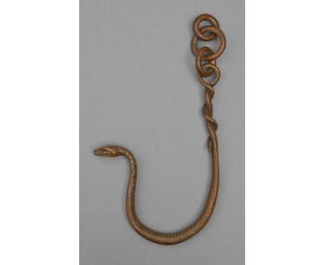 A bronze hanging sculpture of a snake entwined on a chain of three loose rings, 20th c, light brown patina, 31cm h Undamaged