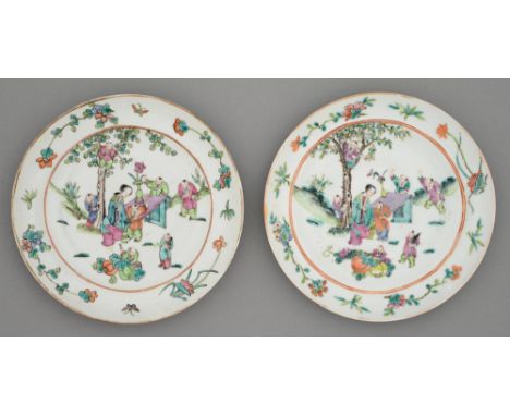 Two Chinese famille rose plates, late 19th c, painted with a lady at a table attended by seven young boys, one in the branche