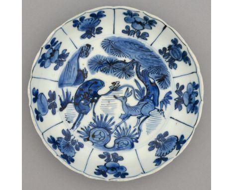 A Chinese blue and white Swatow Ware dish, 17th c, with gently curved cavetto, freely painted with two deer beneath a pine tr