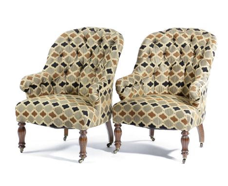 A PAIR OF VICTORIAN WALNUT ARMCHAIRS C.1860-70 later button upholstered, on ribbed baluster front legs and brass castors (2)