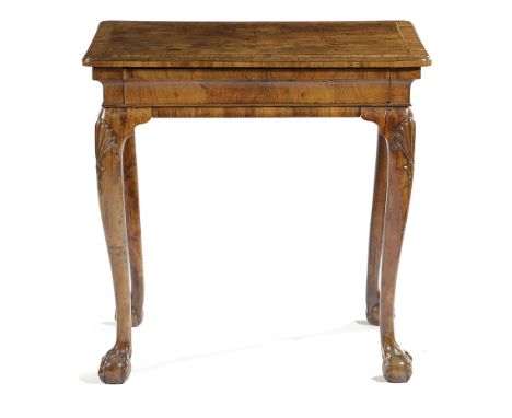 A GEORGE II WALNUT CENTRE TABLE C.1725-30 the quarter veneered top with cross and feather banding and a caddy moulded edge, a