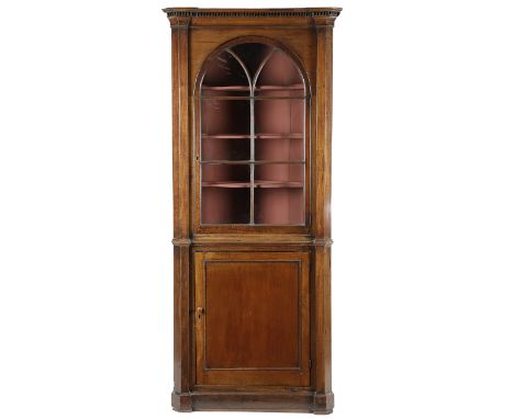 A GEORGE III MAHOGANY STANDING CORNER CUPBOARD C.1770 with an arched astragal glazed door enclosing a later painted interior 