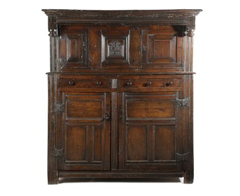 A WILLIAM AND MARY WELSH OAK COURT CUPBOARD DATED '1695' in two parts, the top with two fielded panelled doors, flanking a ca