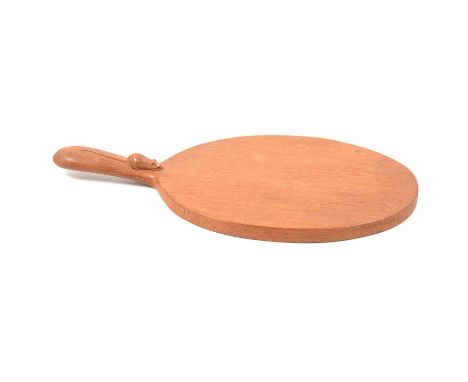 Robert 'Mouseman' Thompson of Kilburn, a carved oak cheeseboard, carved signature mouse to side handle, overall length 37cm.