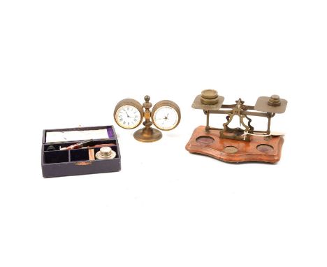 Desk clock barometer, brass case, white enamelled dials, 10cm, and a set of postal beam balance scales, and a seal set, cased