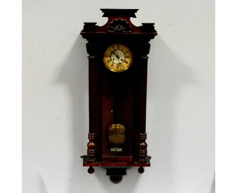 Walnut and stained walnut Vienna wall clock, spring-driven movement striking on a gong, 100cm.