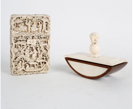 A Chinese carved ivory visiting card case with figures in buildings, terraces amongst prunus blossom, 10.5cm high and an ivor