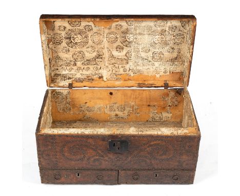 An early 18th Century leather and studwork dome top trunk, scrollwork stud design to the top dated '1705', paper stencilled l