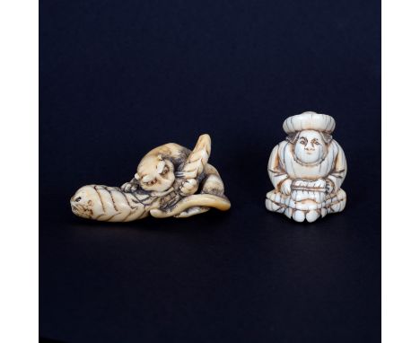 A Japanese carved ivory netsuke of a tiger eating bamboo, Edo period, late 18th Century, 6.5cm long and another late 18th Cen