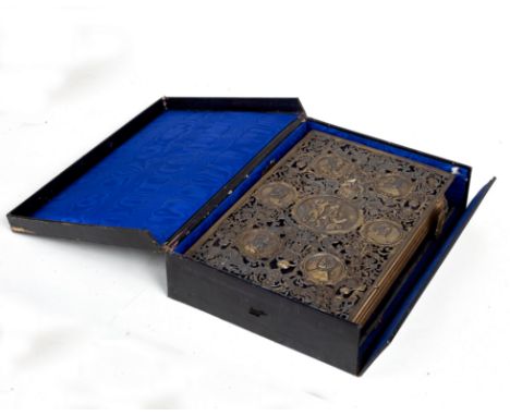 A photo album by Jenner &amp; Knewstub, 33 St James's Street, the album in velvet boards and outer pierced metal covers with 