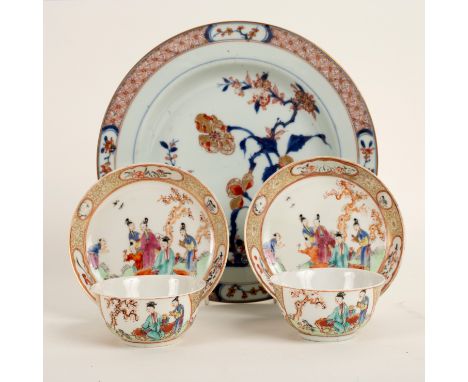 A pair of 18th Century Chinese tea bowls and saucers, decorated amused groups of young women observing copulating dogs with g