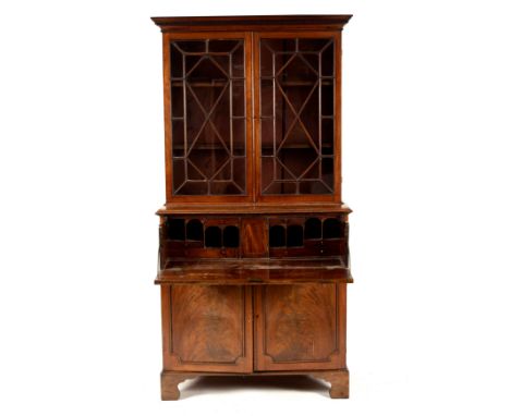 A late Georgian mahogany secretaire bookcase, the glazed upper section above a fitted secretaire drawer with cupboard below, 