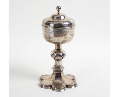 A silver plated covered chalice, the domed cover with plain finial, the knopped stem on a lobed foot, 28cm high 