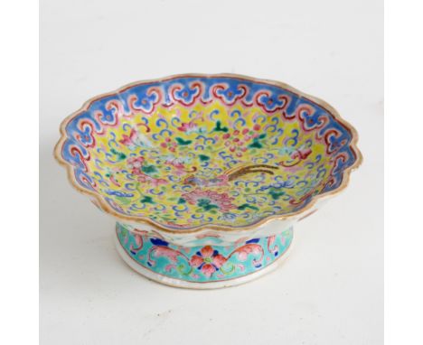 A 19th Century Cantonese tazza enamelled scrolls on a yellow ground within a turquoise border, 13cm diameter CONDITION REPORT