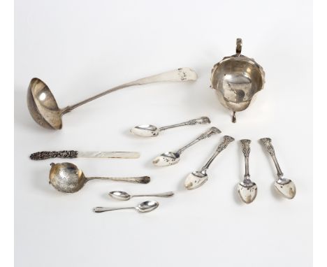 A silver sauce boat, EV, Sheffield 1939, on three scroll feet, a ladle, various spoons and a paper knife with mother-of-pearl
