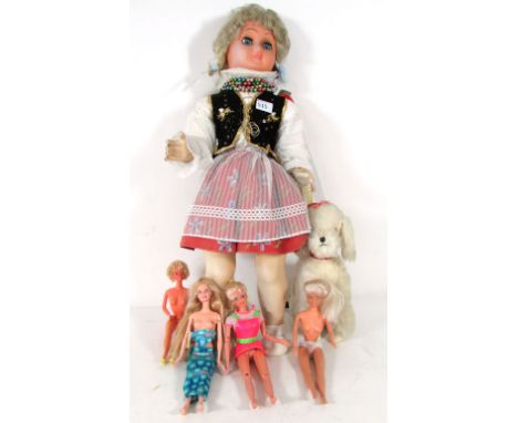 A 1950's plastic country costume doll, with a voice box. h. 70 cm., together with four various dolls to include Mattel Barbie