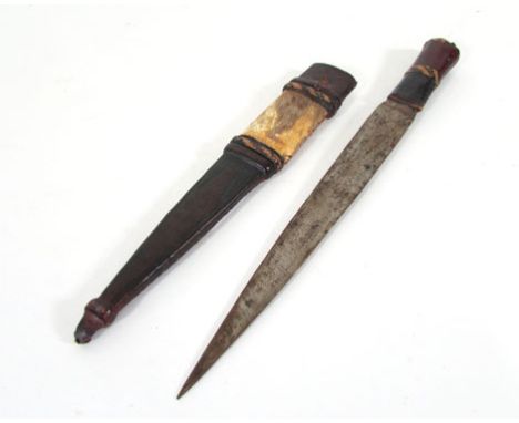 An African dagger, possibly Zulu, with leather and animal hide scabbard and handle, blade l. 24 cm CONDITION REPORT: Wear to 