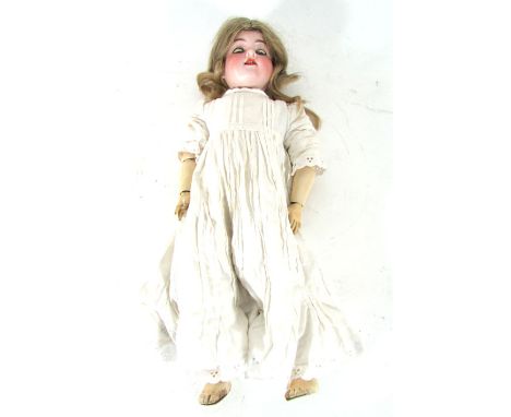 An Armand Marseille bisque headed doll, model 390, stamped DRGM276/1A5M with blue glass sleep eyes, open mouth showing four t