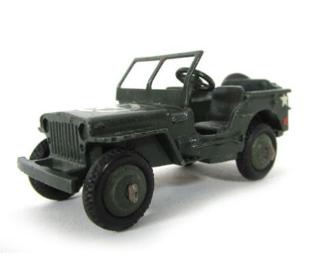 A Dinky American army jeep model 153a, in olive green with white star markings. CONDITION REPORT: In played with condition, w