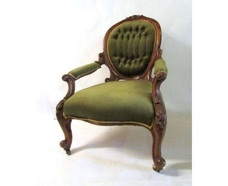 A Victorian walnut framed easy chair, button back rest, serpentine seat foliate carved frame CONDITION REPORT: Generally good