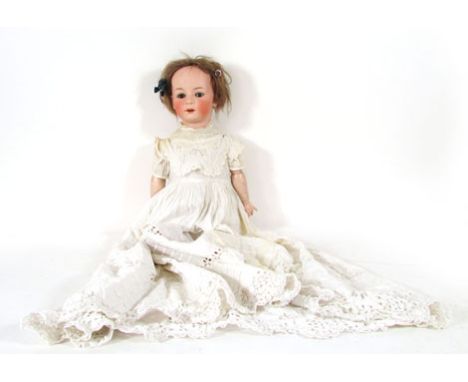 A Heubach bisque headed doll, stamped 12 to neck, with brown glass sleep eyes, open mouth showing four teeth, h. 63 cm CONDIT