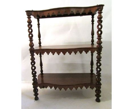 A Victorian rosewood three stage whatnot, three quarter gilt metal gallery above serpentine shelves, shaped aprons, pierced a