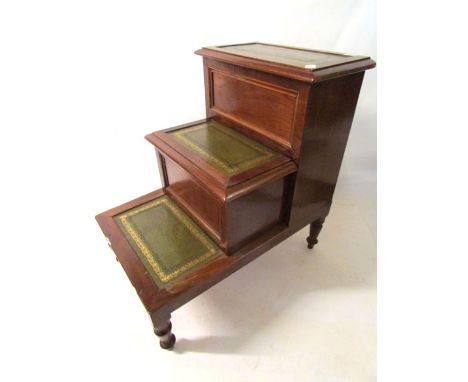 An Victorian mahogany step commode with three tooled leather insets and central step pulling out to reveal commode, hinged to