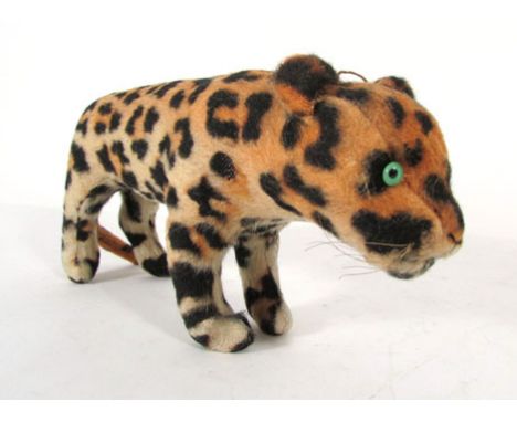 A plush leopard, possibly Chad Valley, standing four square with green and black glass eyes.  l. 38 cm. CONDITION REPORT: Fai
