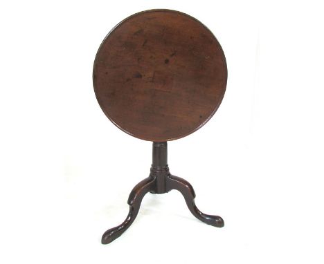 A George lll mahogany circular tilt top occasional table, the tray top on a baluster turned stem and tripod base. h. 71 cm, d