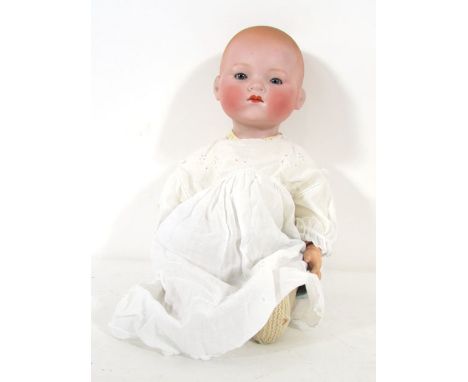 An Armand Marseille bisque headed doll, model 341/8, with painted hair, blue glass sleep eyes, closed mouth. h. 50 cm. CONDIT